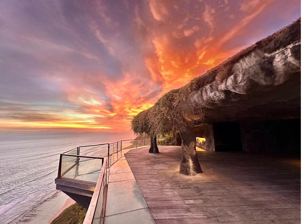Rockfish Cliffside grotto deck with glass balcony at sunset in Uluwatu, Bali